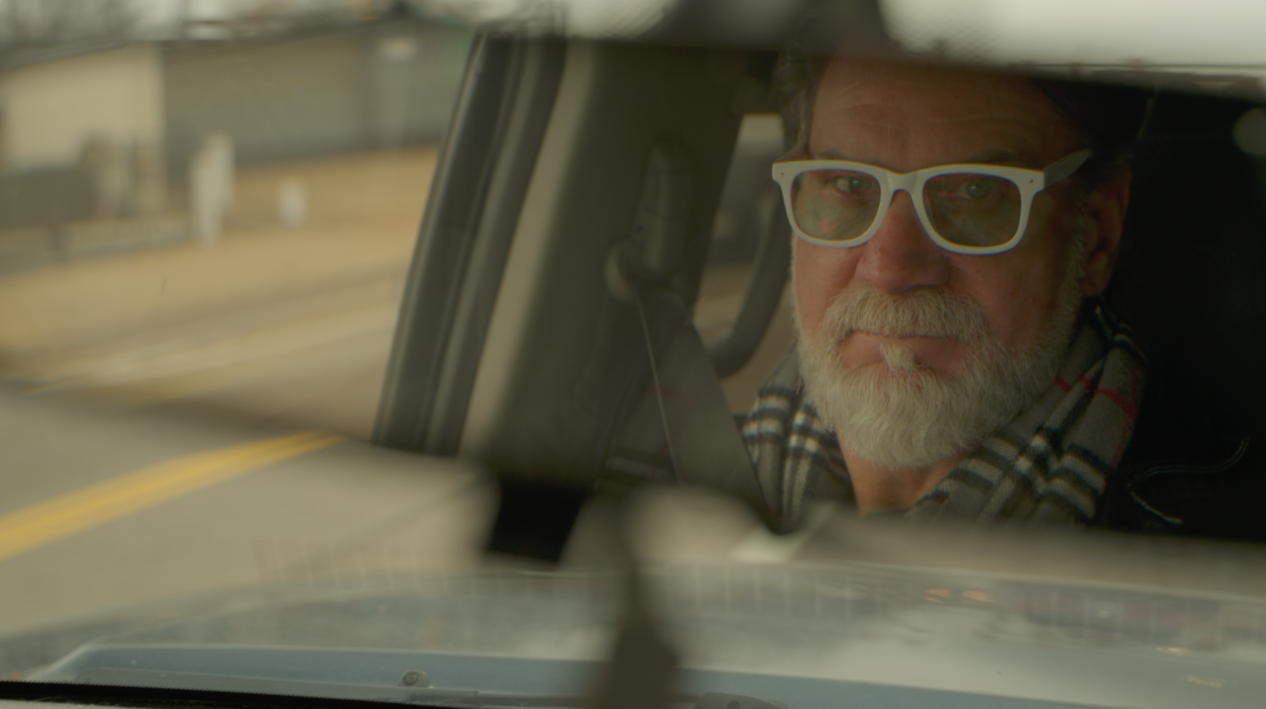 Bill Streeter photographed through a car windshield.
